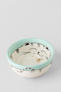 a bowl with a cat face painted on it