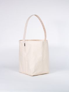 a white canvas bag sitting on top of a table