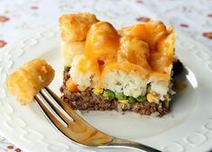 a white plate topped with food and a fork