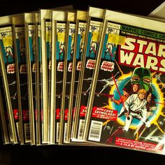 a stack of star wars comics sitting on top of a table