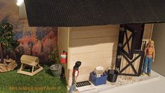 there is a doll house in the middle of a yard with tools and other things