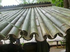 several metal pipes are stacked on top of each other in the middle of an outdoor area