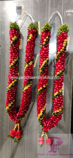 two red and yellow garlands hanging from hooks