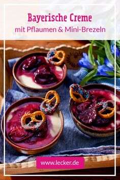 three desserts in small bowls with pretzels on top and blue flowers behind them