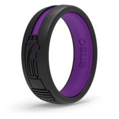 a black and purple wedding band with an etched design on the inside, in front of a white background