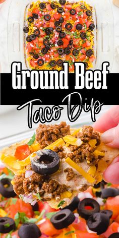 the ground beef taco dip is being held up by someone's hand with black olives