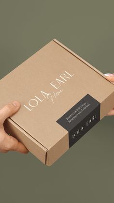 two hands holding a box with the label lora farm