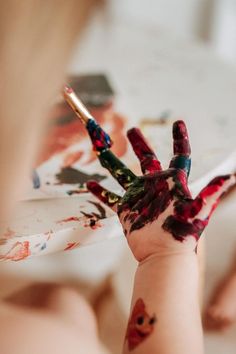 a child's hand with paint on it