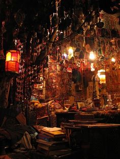 a room filled with lots of different types of items and lights hanging from the ceiling