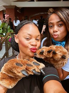 two women are holding stuffed animals in their hands