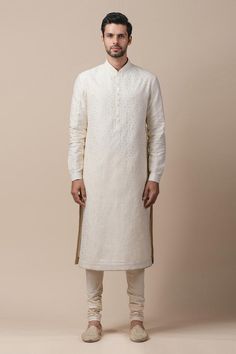 Ivory-gold straight long kurta with all-over applique jaal work, button placket and cuff sleeves. Comes with churidar.
Component: 2
Embroidered
Neckline: Mandarin Collar
Sleeve Length: Full
Fabric: Chanderi, Poplin Lycra
Color: Gold, White
Button placket
Cuff sleeves - Aza Fashions Long Kurtas, Mens Sherwani, Applique Work, Embroidery Shoes, Tarun Tahiliani, Ethnic Looks, Stole Scarf, Scarf Top, Couture Designers