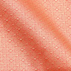 an orange and white pattern on fabric