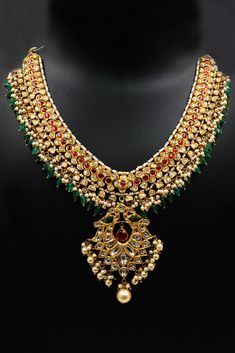 This luxurious 22kt gold necklace is a masterpiece of traditional jewelry, featuring the vibrant combination of emeralds, rubies, and Polki diamonds. Perfectly suited for weddings and grand celebrations, this necklace exudes timeless elegance and is a testament to the rich heritage of handcrafted jewelry. Design and Craftsmanship: Expertly handcrafted by master artisans, this necklace is designed to capture the essence of traditional beauty. The centerpiece of the necklace is a stunning array of Ruby Meenakari Temple Necklace For Festivals, Festive Yellow Gold Kundan Necklace With Ruby, Traditional Ruby Necklace With Meenakari, Traditional Ruby Meenakari Necklace, Traditional Gold Ruby Necklaces, Heavy 22k Gold Necklace For Diwali, Festive Ruby Necklace With Decorative Meenakari, Yellow Gold Ruby Kundan Necklace In Temple Jewelry Style, Yellow Gold Kundan Necklace With Ruby In Temple Style