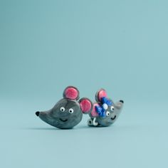 two small figurines of mice with bows on their ears