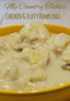 a yellow bowl filled with chicken and fluffy dumplings