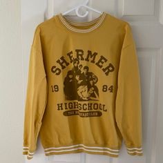 The Breakfast Club Varsity Sweatshirt New Without Tag Size L Never Worn Excellent Condition Measurements (Laid Flat) Bust (Pit To Pit) 22“ Length 24.5" Sleeves 19" Yellow Tops For Fall Streetwear, Trendy Yellow Sweatshirt With Letter Print, Yellow Long Sleeve Sweatshirt With Graphic Print, Oversized Yellow Crew Neck Sweatshirt, Yellow Graphic Print Long Sleeve Sweatshirt, Oversized Yellow Sweatshirt With Letter Print, Yellow Letter Print Sweatshirt For Fall, Retro Long Sleeve Yellow Tops, Retro Yellow Long Sleeve Tops