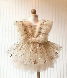 Festive Gold Tulle Dress, Festive Sleeveless Tutu Dress Made Of Tulle, Elegant Gold Princess Dress With Ruffles, Cream Ruffled Tutu Dress For Party, Gold Princess Dress With Ruffles, Gold Ruffled Tutu Dress For Wedding, Gold Princess Dress For Summer Dress-up, Gold Ruffled Dress For Dress-up, Festive Gold Dresses With Ruffles