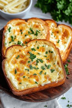 three pieces of bread with cheese and parsley on top