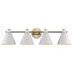 three light bathroom fixture with white shades on the top and gold trimming, in an antique