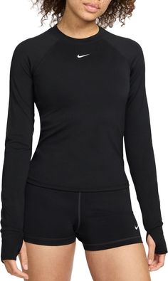 Ready to turn up the heat on your workout? Reach for this fitted long-sleeve top. Thumbholes help keep the sleeves in place through your entire routine. Lightweight and stretchy, the smooth fabric dries quickly and works with you through every move. Mesh panels under the arms let moisture escape so that finishing strong is no sweat. Fit & Design: Fitted Lightweight and stretchy fabric Mesh panels under the arms help increase airflow Thumbholes help keep sleeves in place Nike Dri-FIT technology moves sweat away from your skin for quicker evaporation, helping you stay dry and comfortable Long Sleeve Athletic Shirt, Long Sleeve Workout Shirt, Womens Athletic Outfits, Nike Long Sleeve, Fitness Clothing, Running Tops, Athletic Shirts, Athletic Apparel, Athletic Outfits