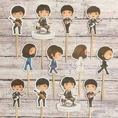 the beatles cake toppers are arranged on sticks