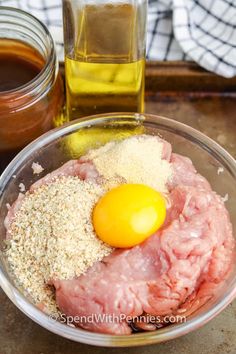 ingredients to make meatballs in a glass bowl with honey and olive oil on the side