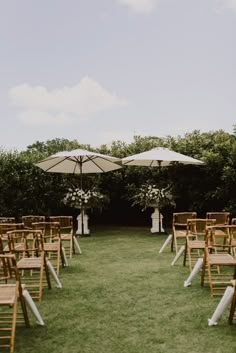 chairs and umbrellas set up for an outdoor ceremony