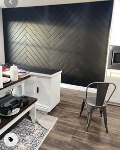 a kitchen area with a table, stove and microwave on the counter next to a chair