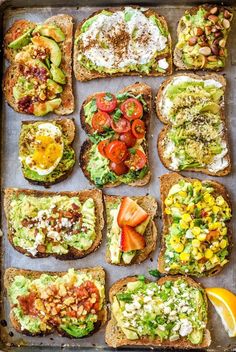 an assortment of toasted breads with different toppings on them, including tomatoes and avocado