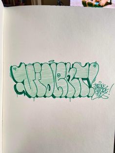 a piece of paper that has some type of graffiti written on it with green ink