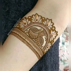 a woman's arm with henna on it