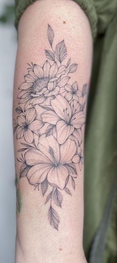 a black and white flower tattoo on the arm