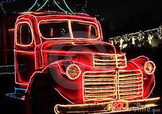 an old truck decorated with christmas lights