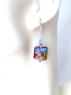 Purple & Blue Flower Earrings Lampwork Dangle Earrings Lampwork Sterling Silver Earrings Pink Handmade Floral Lampwork Glass Flower Jewelry Hand crafted lampwork glass earrings with pink, purple, blue and green flower motif and Swarovski crystal on sterling silver ear wires Length: 1.8 inches from the top of the wire The earrings will arrive with a Marty White card in a lovely decorative bag, all wrapped in a tissue paper and bubble wrap packaging. **Mark my shop as a favorite as the inventory of unique handmade jewelry is continually growing and changing! Thanks for shopping!! Please visit my jewelry shop often...2011-189e Blue Flower Earrings, Wrap Packaging, Jewelry Hand, Flower Motif, Earrings Pink, Green Flower, Unique Handmade Jewelry, Flower Jewelry, Glass Earrings