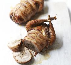 two pieces of meat sitting on top of a cutting board