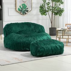 a living room with a green chair and ottoman