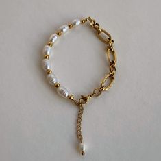 The bracelet is crafted with a combination of natural freshwater pearls and a stainless steel chain. This accessory will easily add a touch of accent to your everyday look. Material: Stainless steel & Freshwater Pearls. Finish: 18k Gold Plated. Width: 5mm. Length: 18,5cm+4cm. 🔸more from us🔸 https://www.etsy.com/shop/DoraJewelryAccessory Adjustable Metal Chain Bracelet With Pearl Charm, Metal Pearl Bracelet With Charm As Gift, Metal Pearl Bracelet With Pearl Charm As Gift, Pearl Charm Bracelet In Metal As A Gift, Metal Pearl Bracelet With Pearl Charm For Gifts, Pearl Chain Metal Bracelet Gift, Adjustable Metal Pearl Chain Bracelet, White Metal Pearl Bracelet With Jubilee Details, Metal Beaded Pearl Bracelet As A Gift