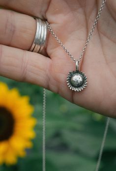 This dainty sunflower charm is hand-sawn from sterling silver, hand stamped and formed to resemble the cutest of summer flowers. It is strung on your choice of a 16" or 18" sterling silver rolo chain. This necklace pairs perfectly with my sunflower earrings. The essential summer jewelry for the flower lover.  This item is made to order. Please allow up to three weeks turn around time. Please ask any and all questions before purchasing. This item is handmade, there may be slight variations or imperfections. Everyday Jewelry With Flower Charm Round Pendant, Everyday Jewelry With Round Flower Charm Pendant, Nickel Free Flower Pendant Charm Necklaces For Everyday, Silver Flower Pendant Charm Necklace For Everyday, Nickel-free Flower Pendant Charm Necklaces For Everyday, Silver Flower Charm Necklace For Everyday, Silver Charm Necklace With Flower Charm For Everyday, Silver Everyday Charm Necklaces With Flower Charm, Sterling Silver Flower Pendant Necklace For Everyday