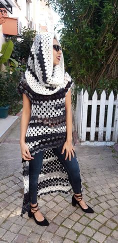 a woman wearing a black and white knitted shawl