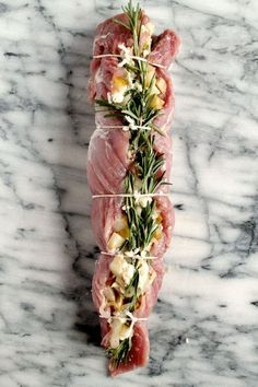 raw fish fillets with herbs and cheese on marble counter top, ready to be served