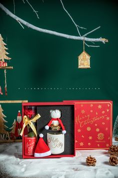 an open christmas gift box sitting on top of snow covered ground