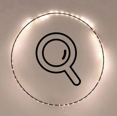 a magnifying glass on the wall with lights around it