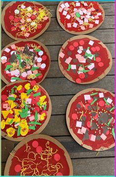 four pizzas are decorated with hearts and confetti