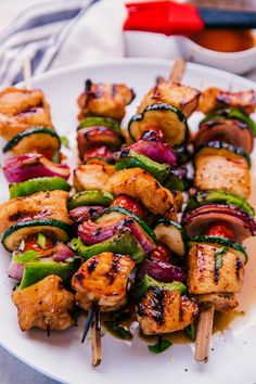 chicken and vegetable kabobs on skewers served on a white platter