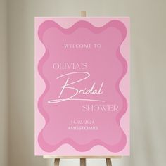 a welcome sign for a bridal shower on an easel in front of a white wall