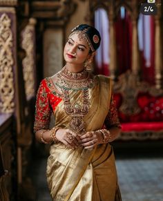 a woman in a gold and red sari