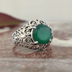 ...4 carats of rich green show! Be a head-turner with this sterling silver designer green onyx ring we appropriately named - Envy Ring! Its green onyx center and extravagant filigree details will have you feeling like royalty. The ring measures about 16mm in the front and tapers down to 1.75mm in the back. The round faceted green onyx center measures 10mm - 4 carats of rich green show! Perfect for adding a touch of flair to any outfit, this ring's captivating color and design is sure to get noti Rich Green, Onyx Ring, 50th Gifts, Green Onyx, Personal Marketing, Free Giveaway, Nature Beauty, Sterling Silver Jewelry, Onyx