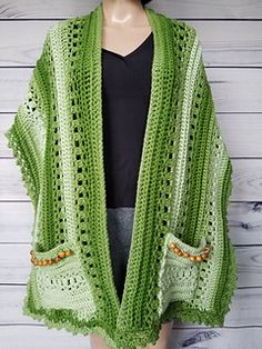 a woman wearing a green crocheted shawl