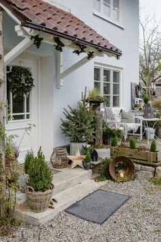 a house with potted plants in front of it and other decorations on the outside