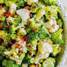 a bowl filled with broccoli, cauliflower and cheese